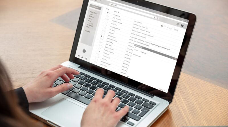 Email client list, woman hand on the computer laptop, inbox e mail message on the screen, close up