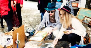 Friends choosing picture frames at flea market