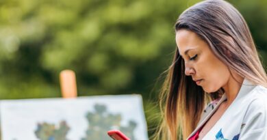 Painter using a mobile in a park