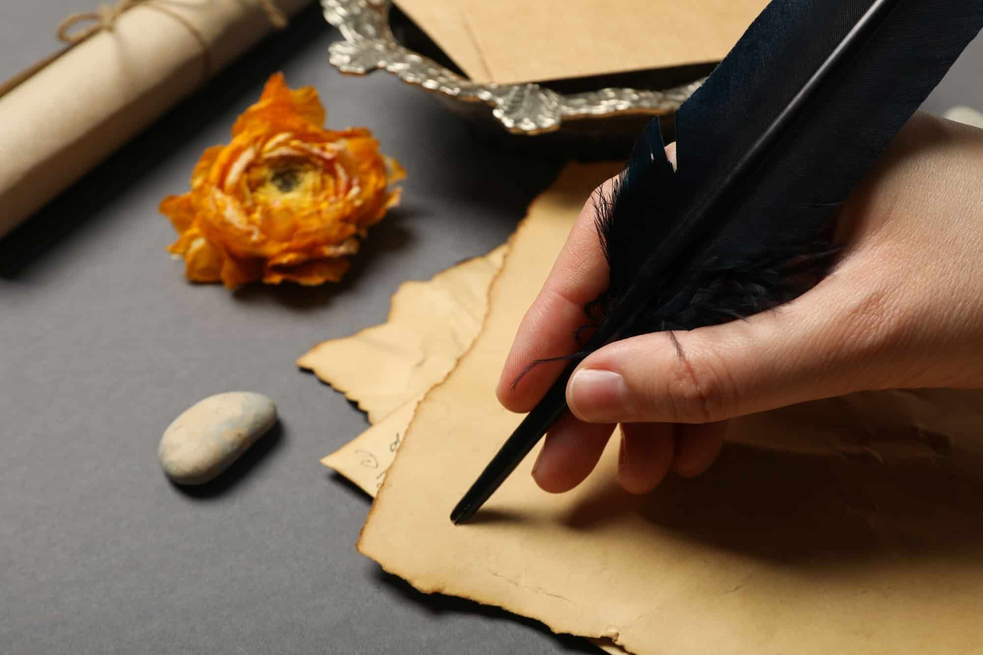 A man writes a love letter with an antique pen