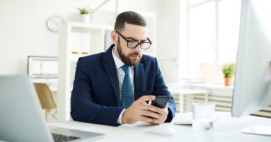 Businessman reading sms in office