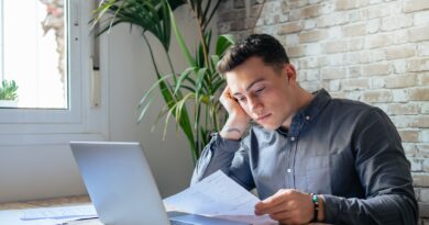 Confused frustrated young man reading letter, debt notification, bad financial report