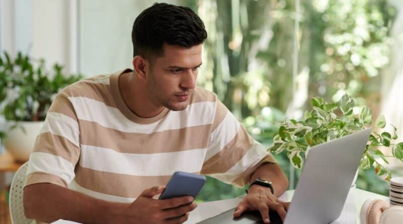 Man Answering E-mails on Laptop